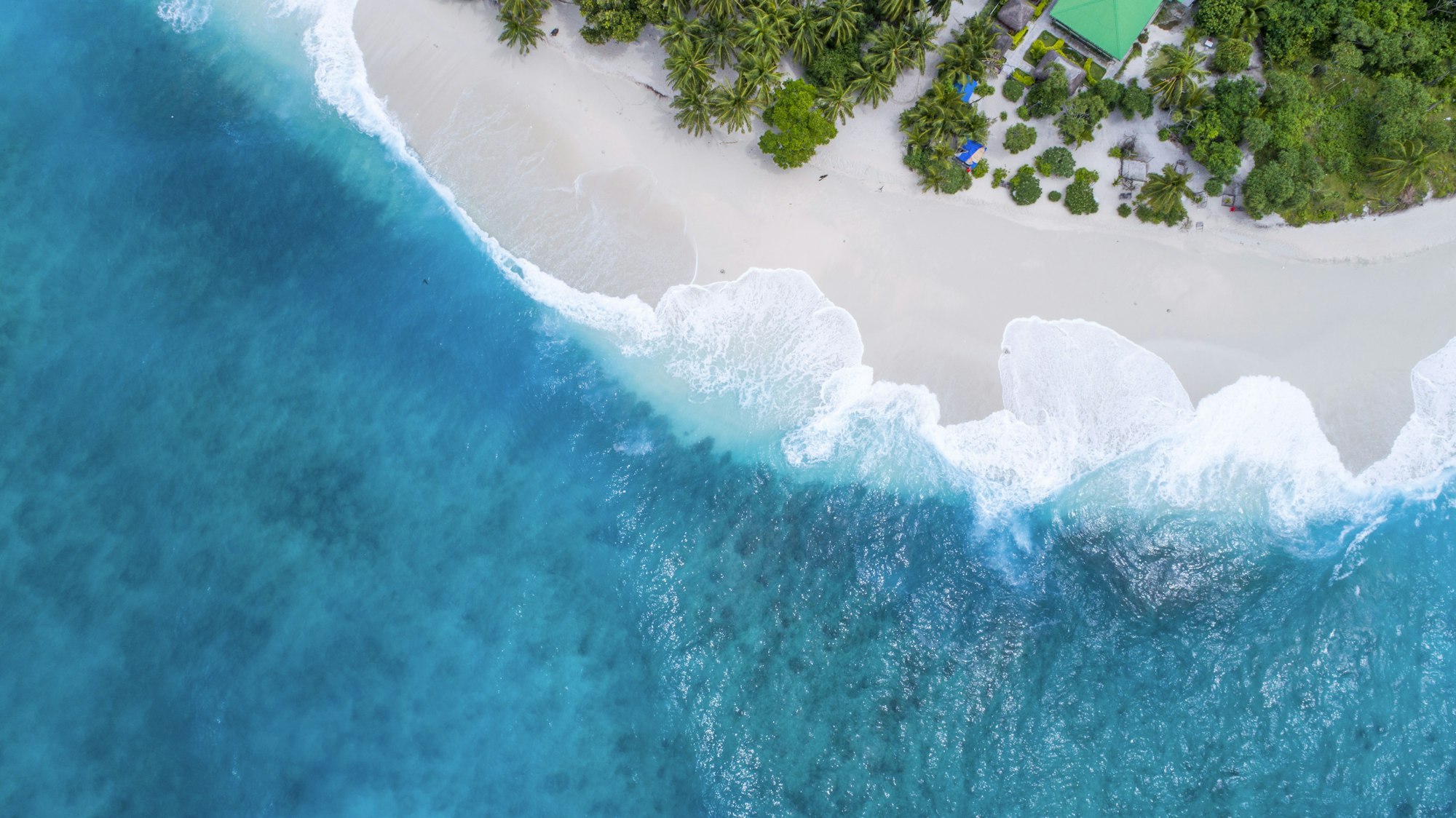 Turquoise water and white sand beach at golden hour on Mactan Island, Cebu